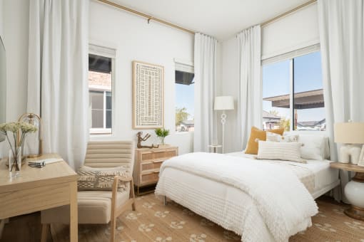 a bedroom with a bed and two windows