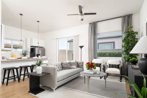 a living room with a couch and a table and a kitchen