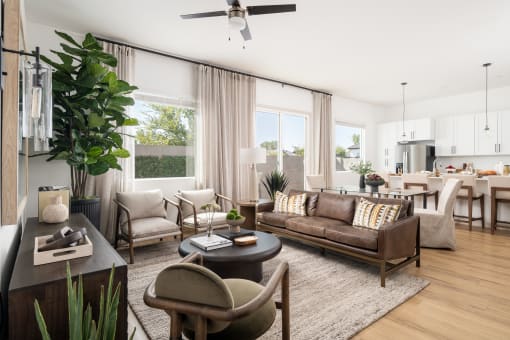 a living room with a couch and chairs and a table