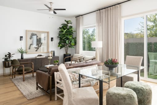 a living room filled with furniture and a large window