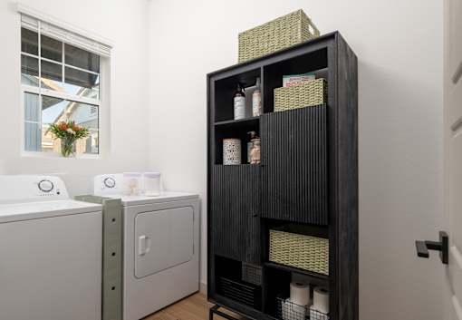 A black shelf with various items on it in a room.