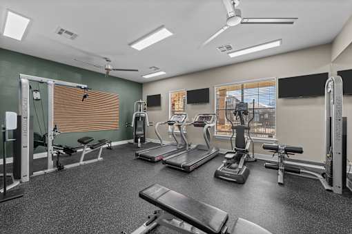 A spacious gym with treadmills, exercise bikes, and other equipment.