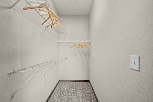 A hallway with a light switch on the wall.