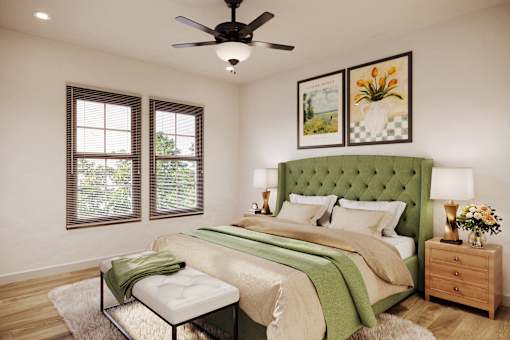 A bedroom with a green headboard and a white bed.