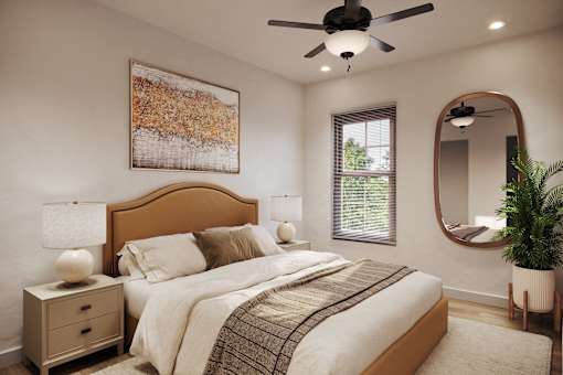 A bedroom with a large bed, a ceiling fan, and a painting on the wall.