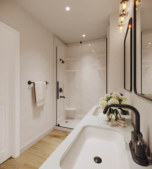 A white sink in a modern bathroom with a glass shower door.