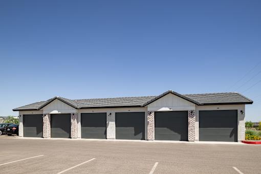 A building with a parking lot in front.