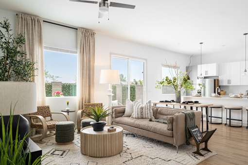 A modern living room with a sofa, chairs, and a coffee table.