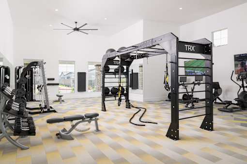 A TRX suspension trainer is hanging from the ceiling in a gym.