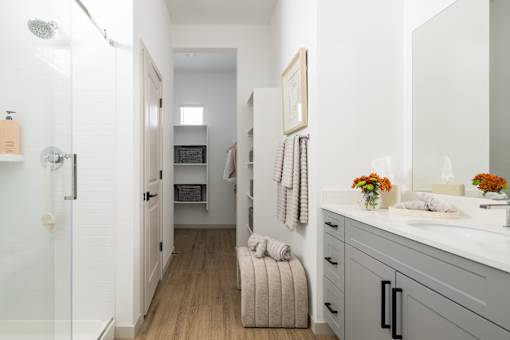 A bathroom with a white sink and a mirror.