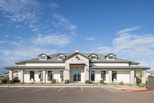 A white building with a red line in front of it.