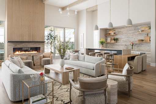A modern living room with a fireplace and a variety of seating options.
