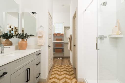 A bathroom with a white sink and a mirror above it.