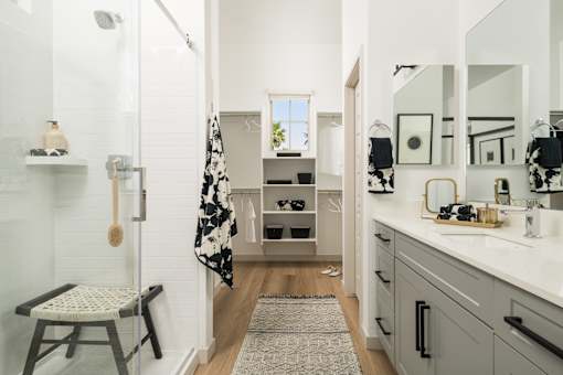 A bathroom with a chair and a mirror.