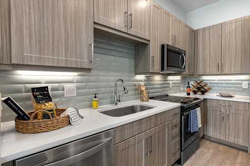 A modern kitchen with wooden cabinets and stainless steel appliances.