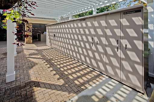 A large, beige, patterned gate blocks the view of a building.