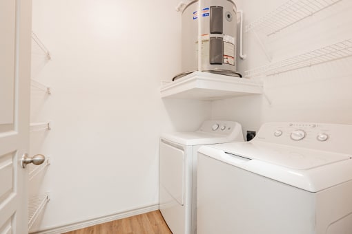 a laundry room with a washer and dryer and a coffeemaker in