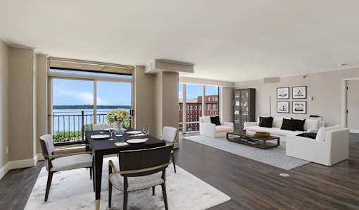 A dining room with a table set for two and a view of the balcony.