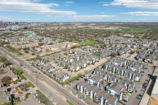 A suburban neighborhood with houses and a road.