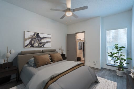 a bedroom with a large bed and a ceiling fan
