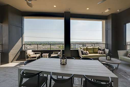 A modern dining room with a table set for six.