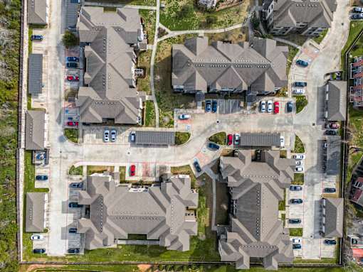 A bird's eye view of a residential area with houses and cars.