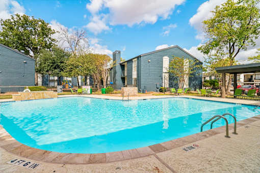 A swimming pool with a blue tiled edge and a metal ladder.