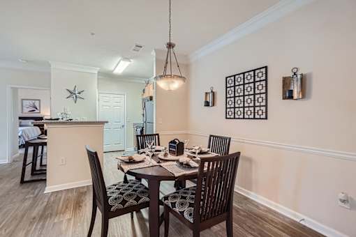 A dining room with a table set for six.