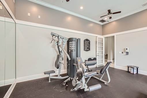 A home gym with a weight machine and a bench.