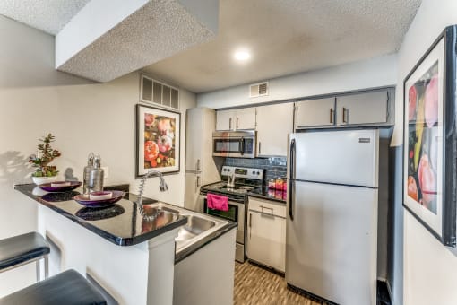 our spacious kitchen with stainless steel appliances and granite counter tops
