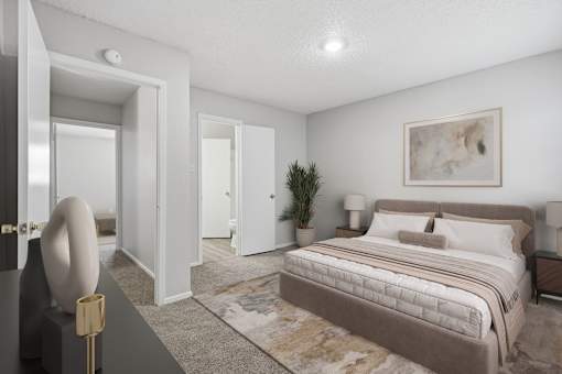 A bedroom with a large bed and a painting on the wall.