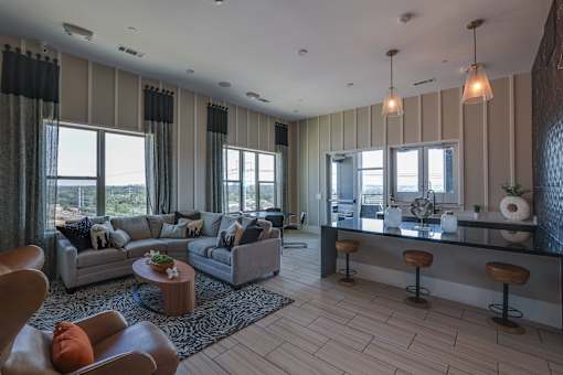 A modern living room with a large window and a bar area.