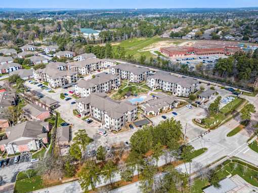 A large apartment complex with a swimming pool and a gym.