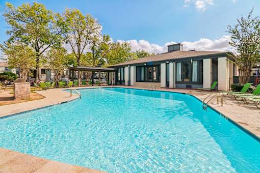 A swimming pool in front of a house.