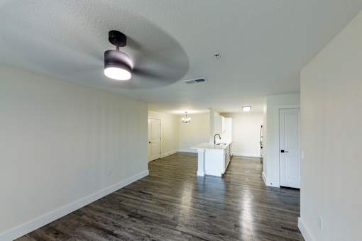 A spacious room with a white table and a light fixture on the ceiling.