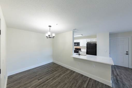 A kitchen area with a counter and a fridge.