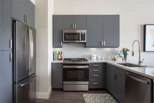grey kitchen appliances and grey cabinets in kitchen