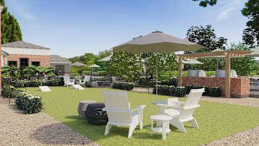 A patio with white chairs and a table is surrounded by a garden.