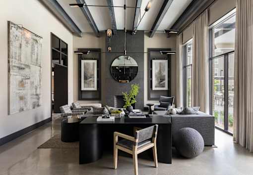 A modern living room with a black and white color scheme.