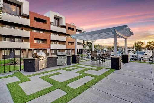 A modern building with a green lawn in front.