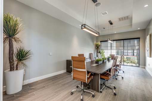 a conference room with a long wooden table and chairs