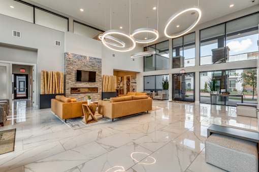the lobby of a condo with couches and a fireplace