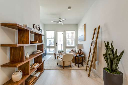 a living room with a couch and a chair and a plant
