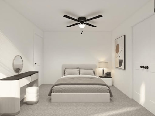 A bedroom with a bed, nightstand, and a ceiling fan.