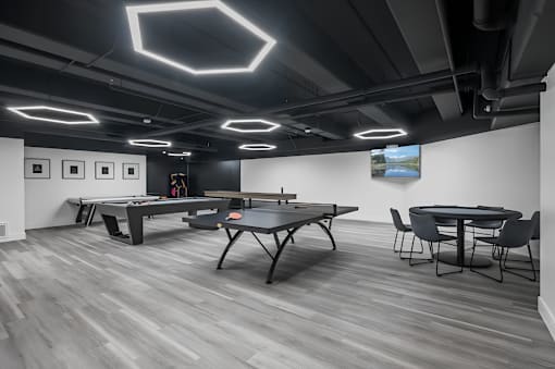 A room with a pool table and a ping pong table.