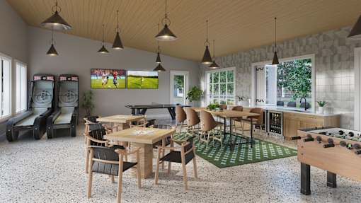 A room with a foosball table and a couch.