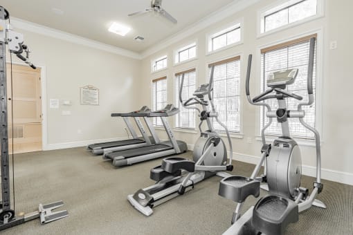the gym with treadmills and ellipticals at the preserve at great neck apartments