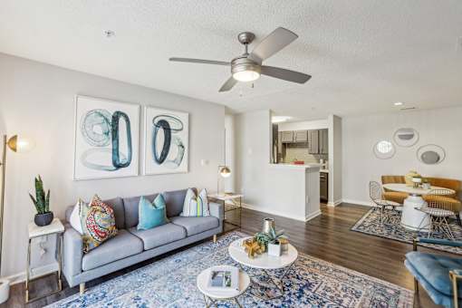 A living room with a grey couch and a white coffee table.