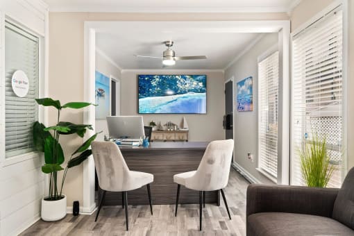 a home office with a desk and chairs and a computer