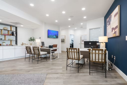 a living room and dining room with a table and chairs